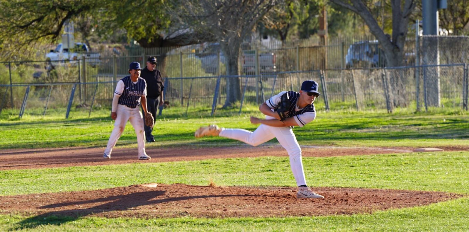A Pueblo baseball players throws a pitch
