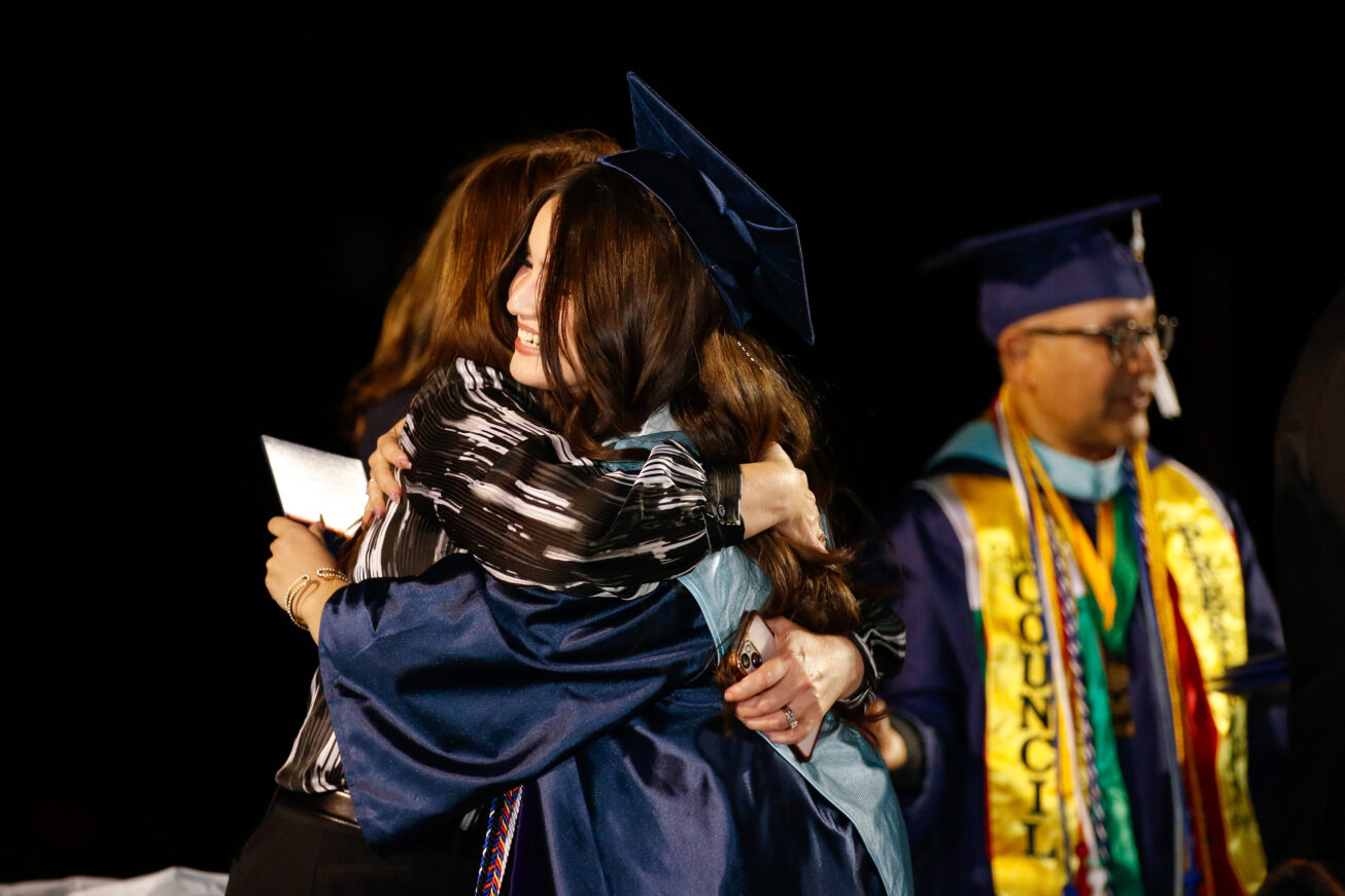 A Pueblo grad gives a hug during the ceremony