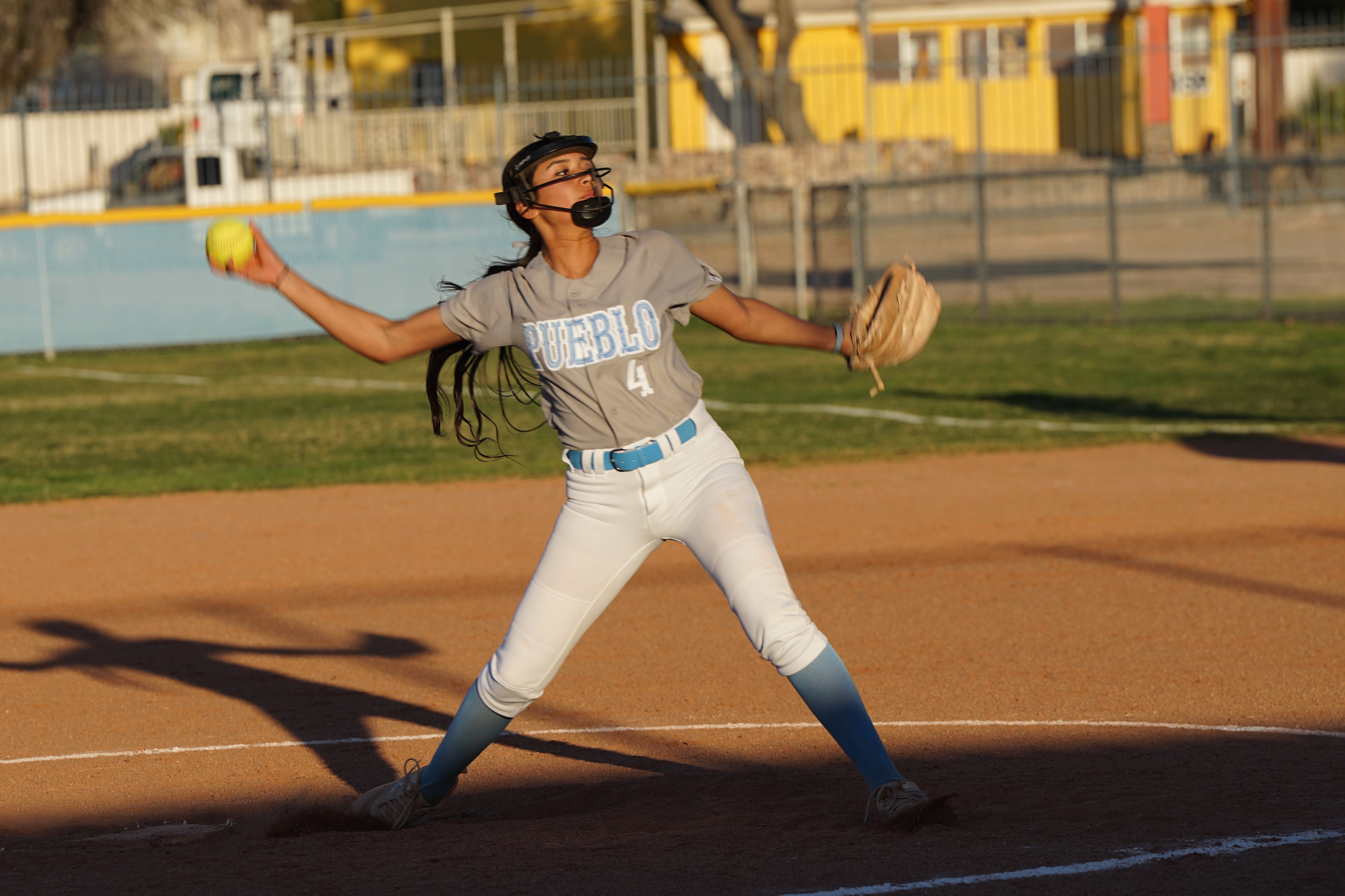 A softball player throws out the ball