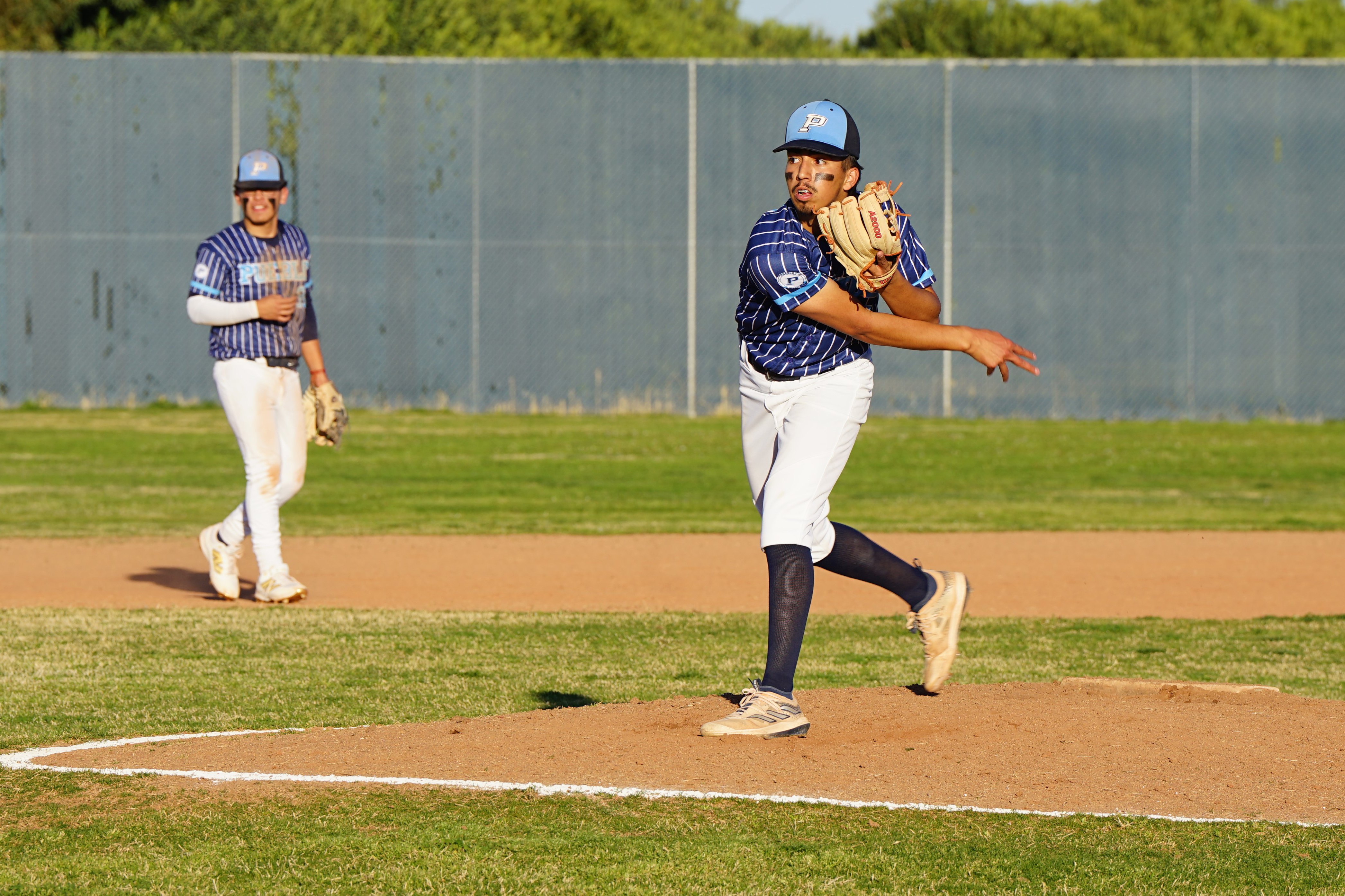 A Pueblo baseball player throws the ball