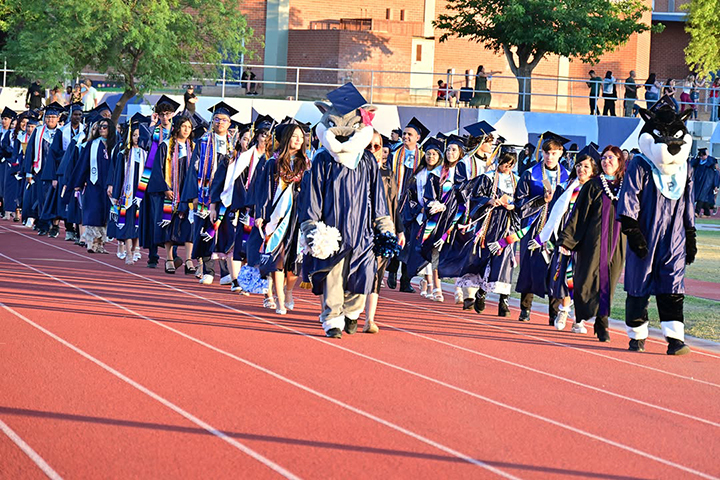 Pueblo's mascots lead the graduates into the stadium