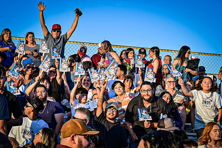 Families cheer the grads from the bleachers