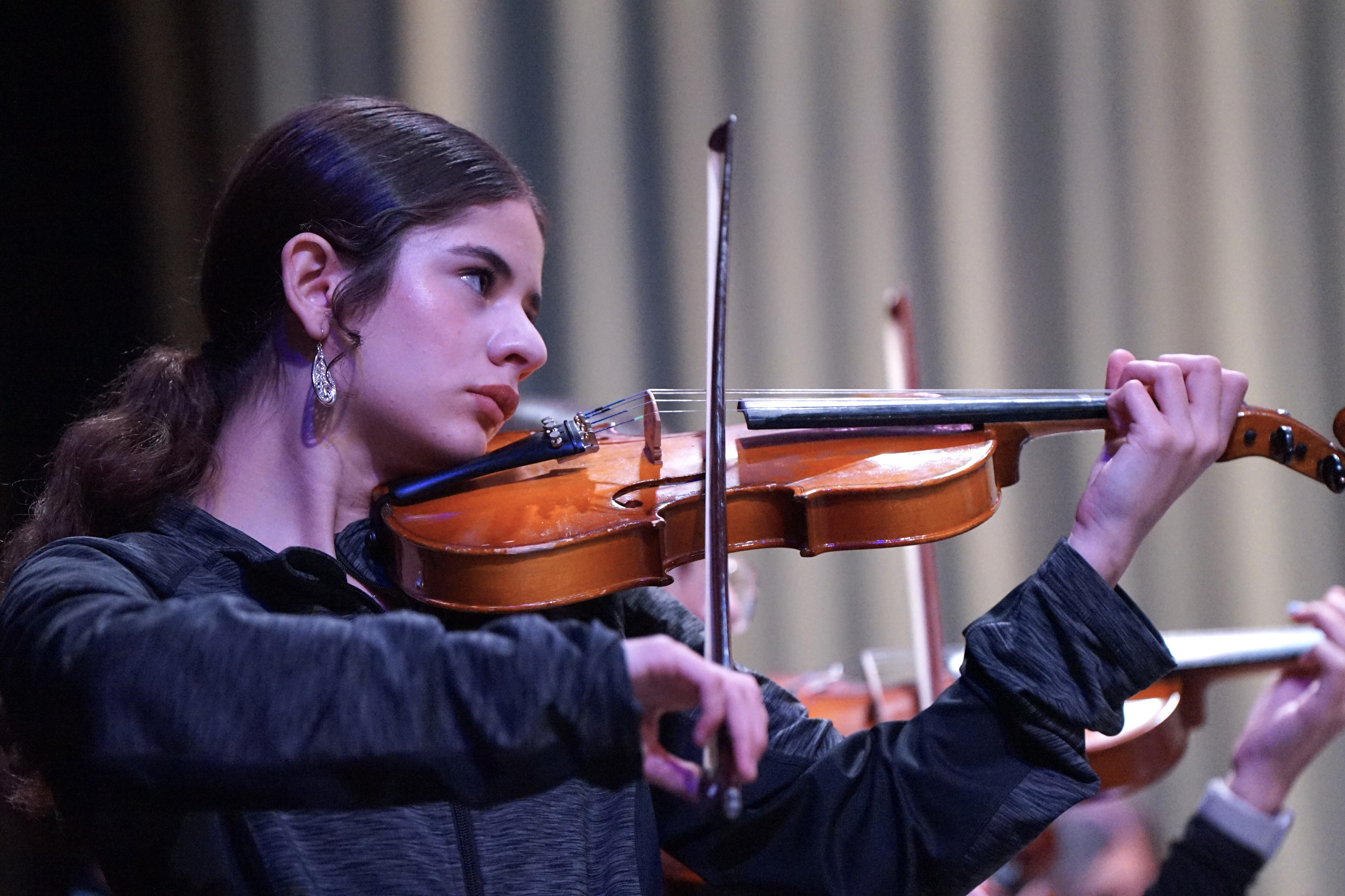 A girl plays her violin