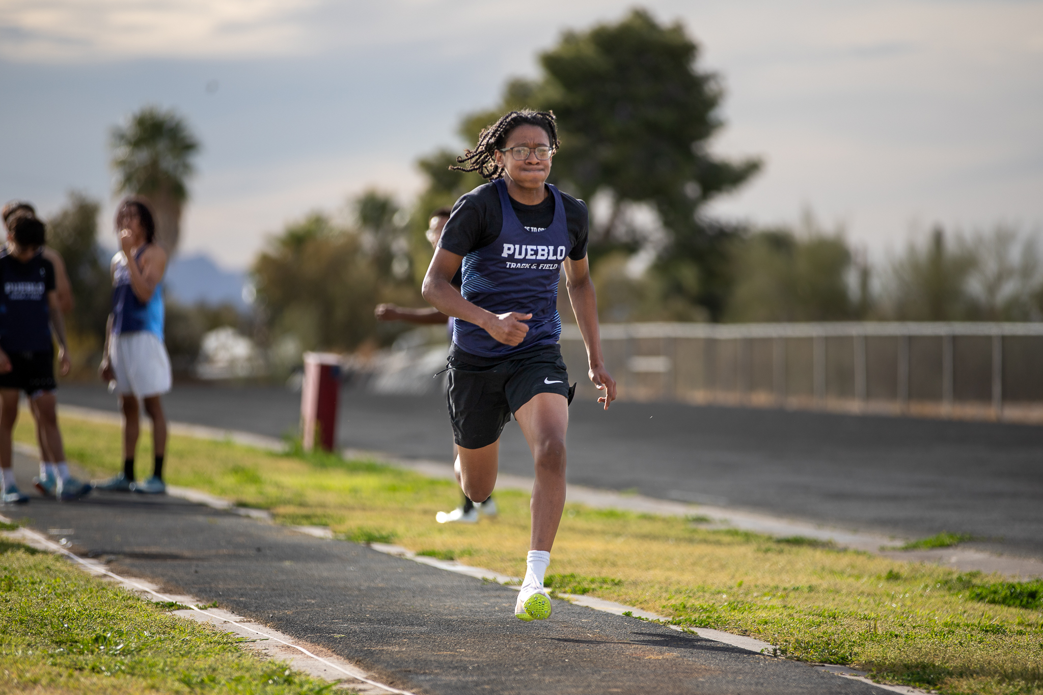 A teen boy sprints down the track