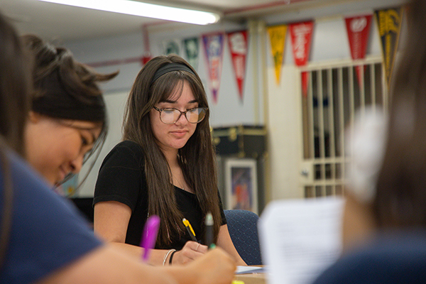 A teen girl works on an assignment