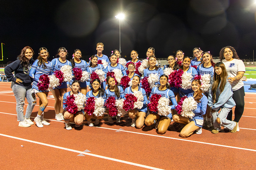The Pueblo cheer squad posing for a group photo on the track