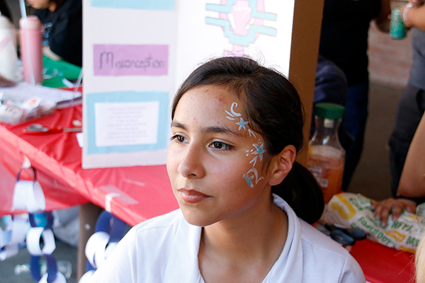 A girl shows off her face paint