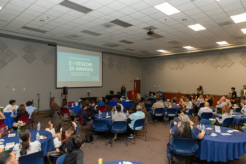 People sit around tables at an awards banquet