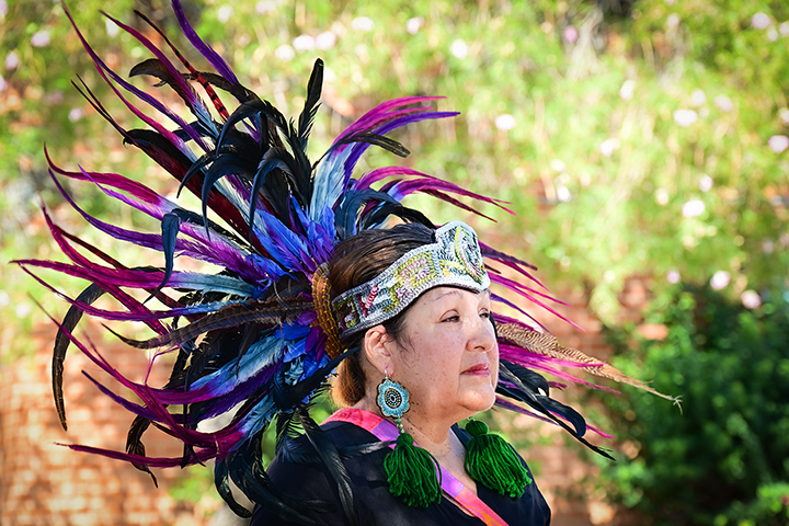 A woman in a colorful feathered headdress