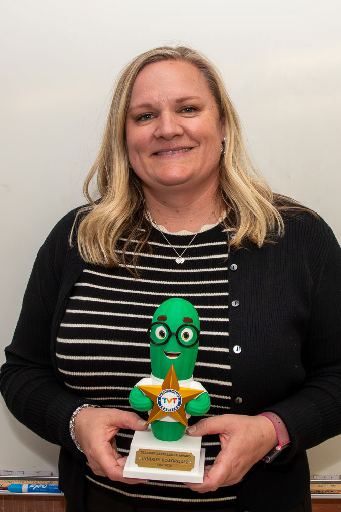 Teacher receives the cactus-shaped award.