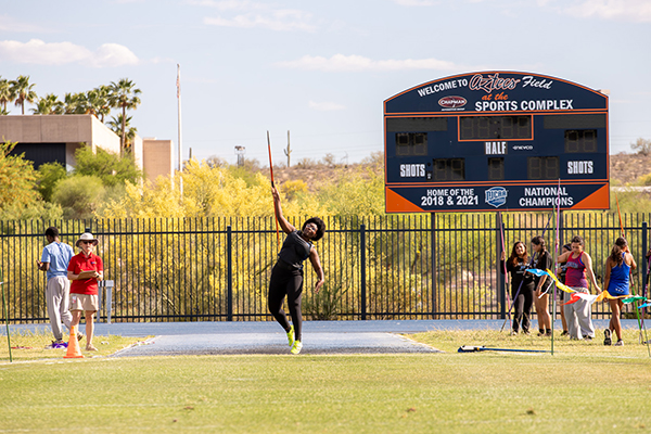 A teen girl throws a javelin