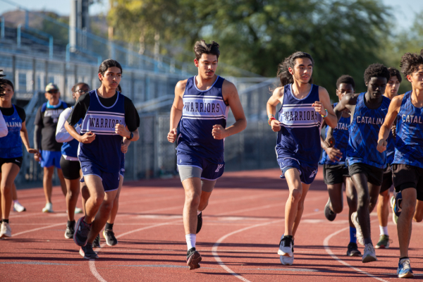 Members of the Warriors cross country team run on the track